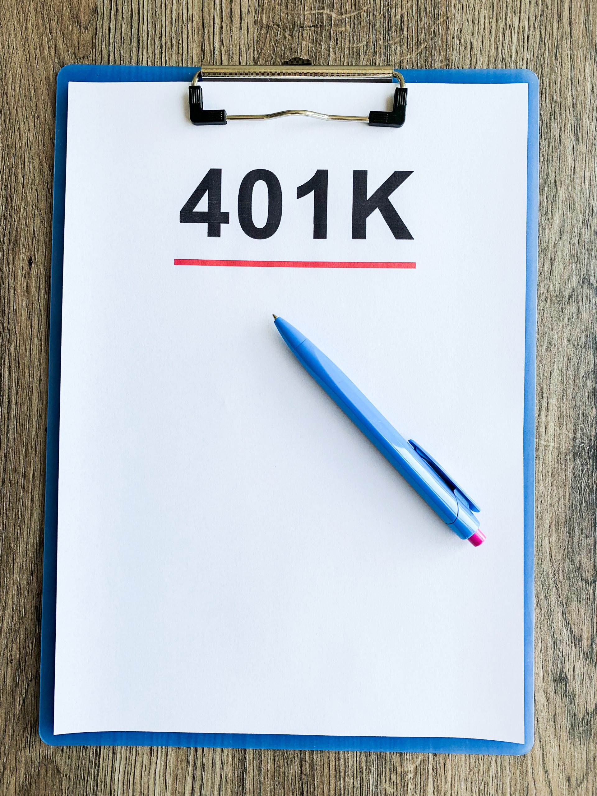 Paper with 401k plan on wood table