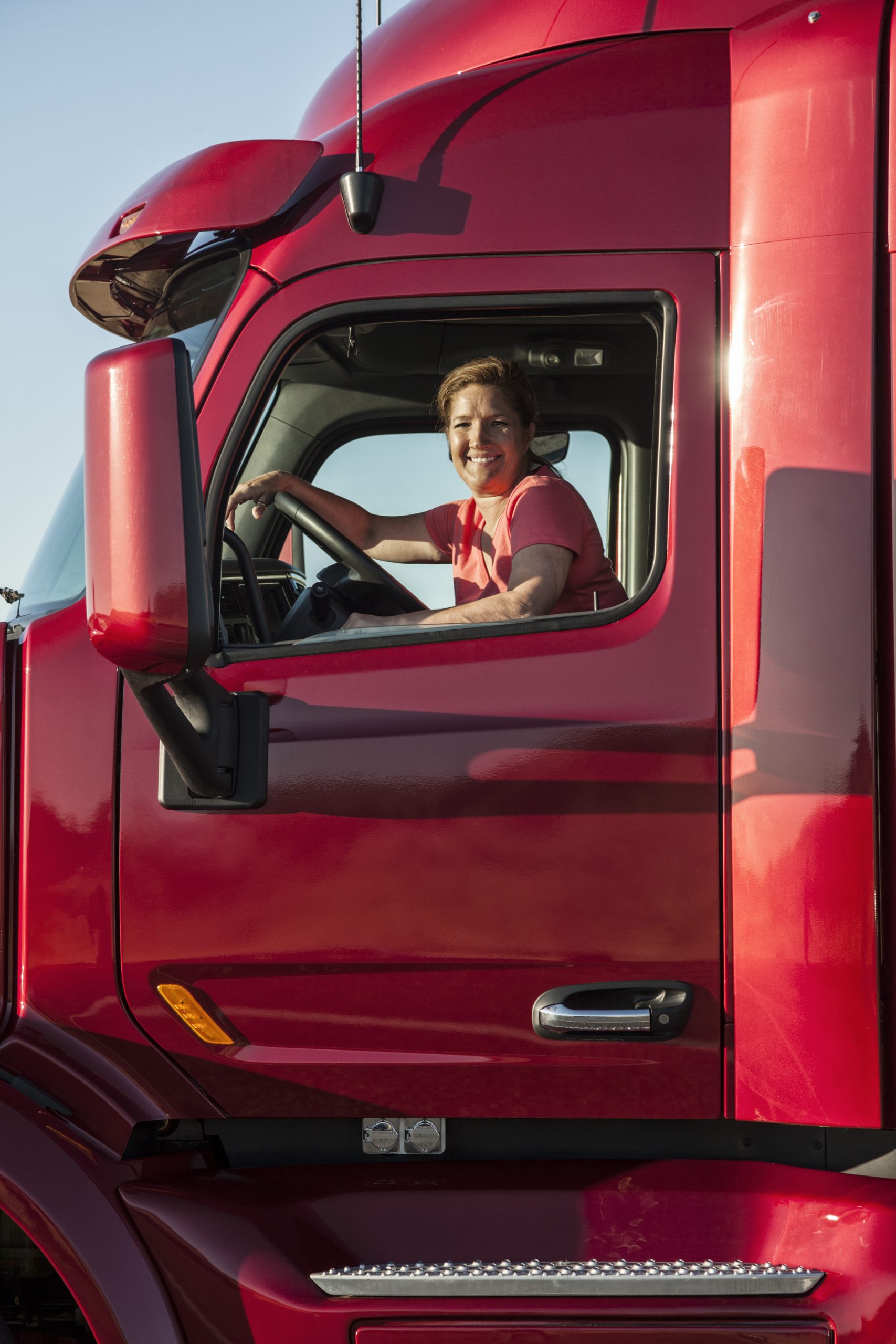 Portrait of a woman driver and her commercial truck.