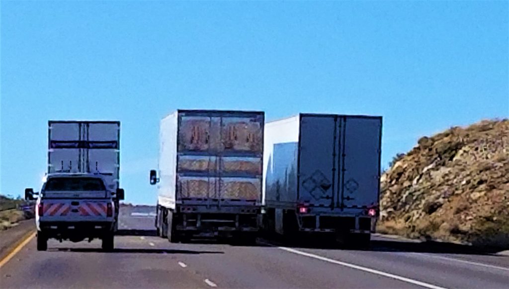Transportation and Logistics! Three Big Rig Semi Trucks Side by Side on the Highway!